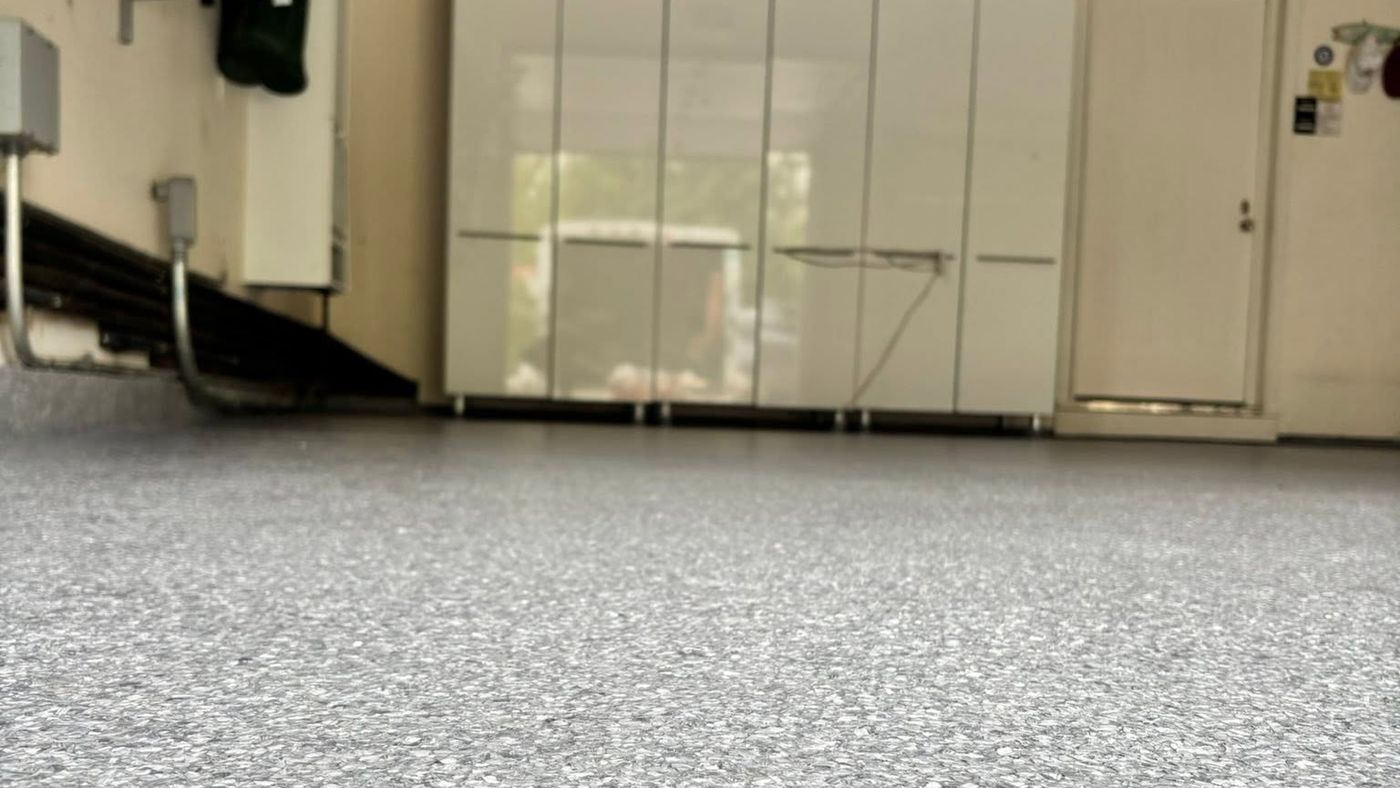 Garage floor after epoxy coating: gray flake epoxy garage floor installed by Naperville Painting & Epoxy Flooring
