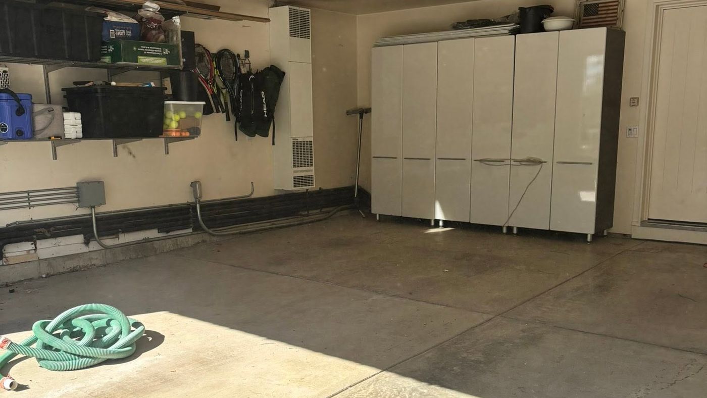 Garage floor before epoxy coating: stained, cracked bare concrete ahead of a garage floor coating by Naperville Painting & Epoxy Flooring