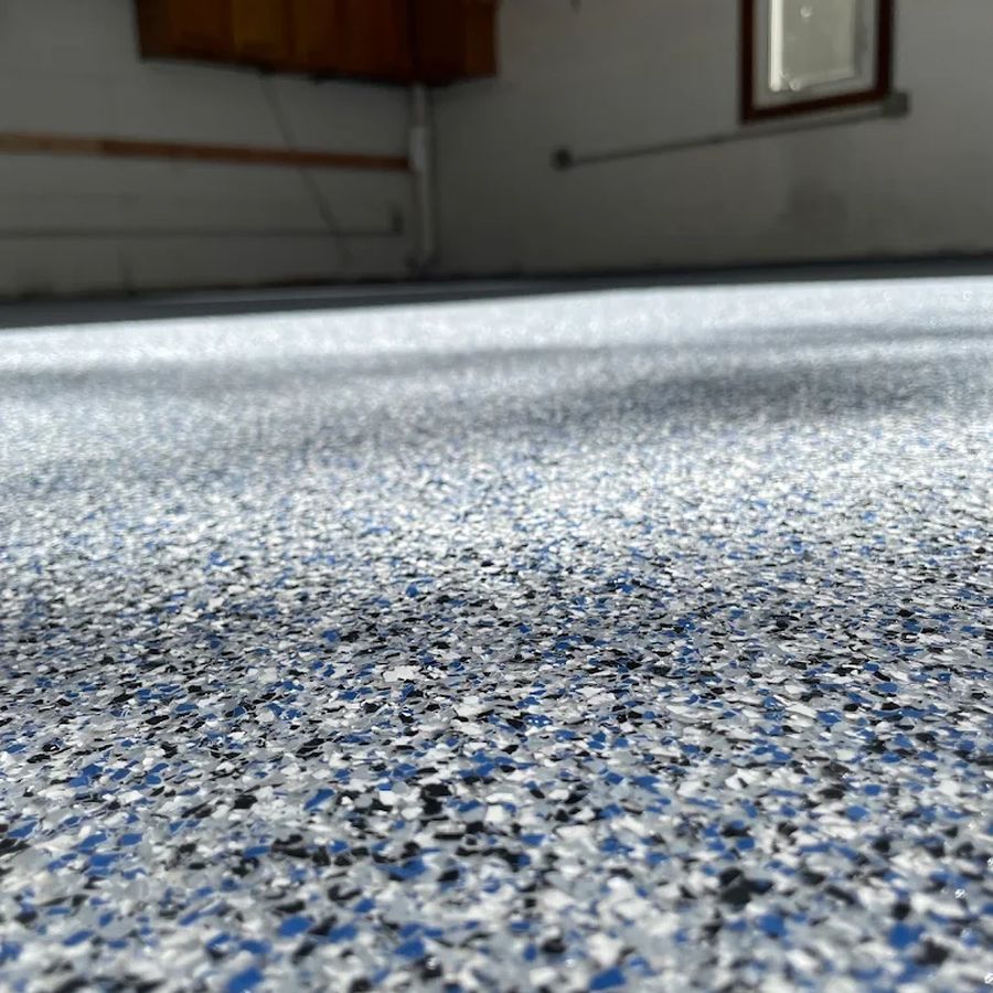 Low-angle view of a blue flake epoxy garage floor coating by Naperville Painting & Epoxy Flooring