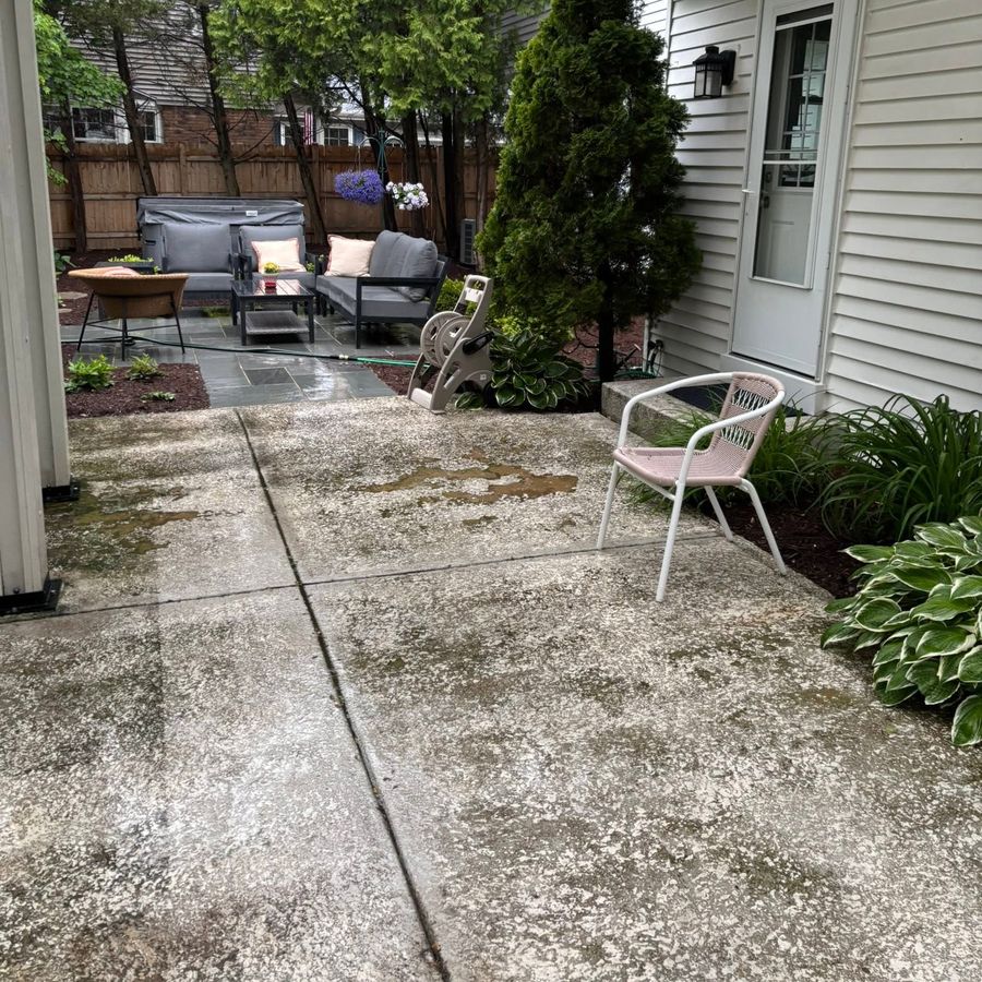 Before: stained, weathered concrete patio under a pergola