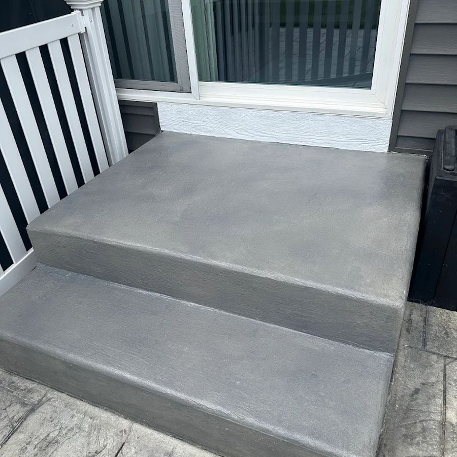 Resurfaced concrete porch steps with a smooth gray coating