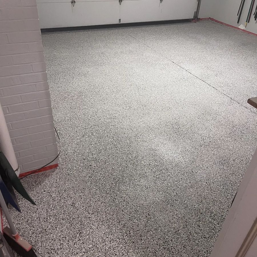 Gray, black and white flake epoxy floor in a two-car garage by Naperville Painting & Epoxy Flooring