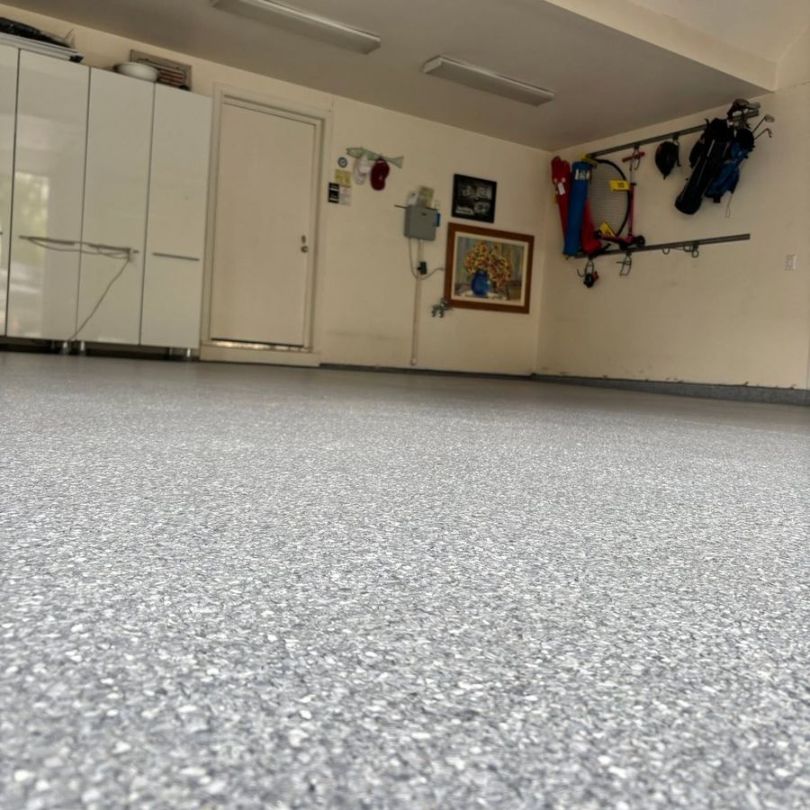 Gray flake epoxy garage floor coating in a finished garage by Naperville Painting & Epoxy Flooring