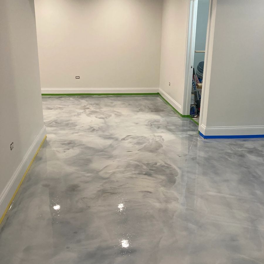 Silver metallic epoxy floor in a finished basement room