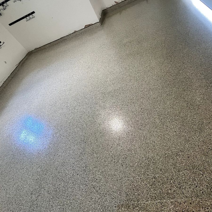 After epoxy: crack repaired and coated with a tan flake epoxy garage floor by Naperville Painting & Epoxy Flooring