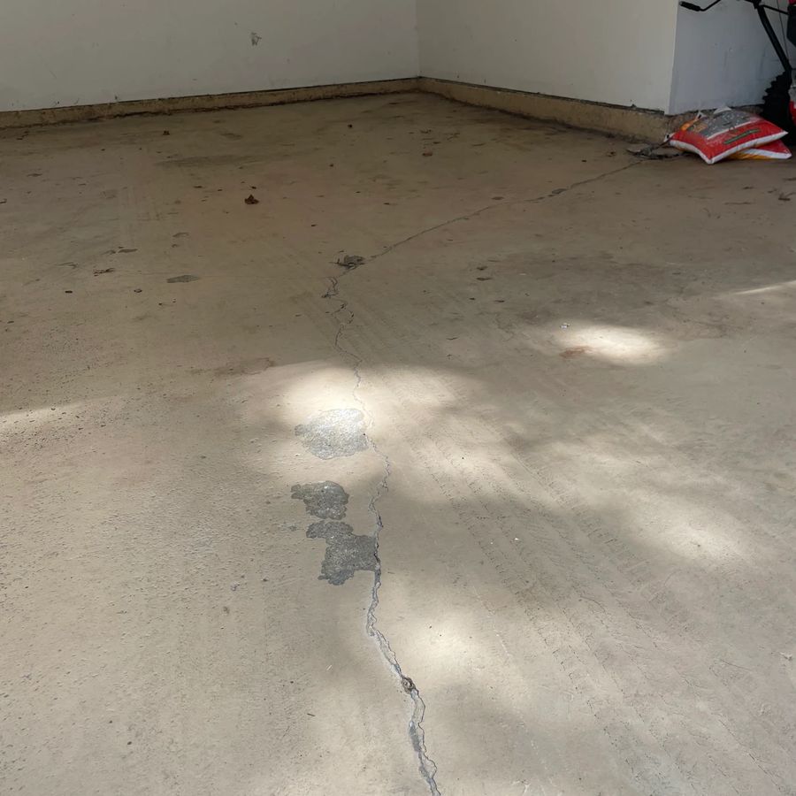 Before epoxy: cracked, stained concrete garage floor